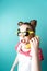 Modern technology: A teenager girl in funny glasses uses a yellow banana as a phone.