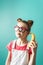 Modern technology: A teenager girl in funny glasses uses a yellow banana as a phone.