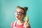 Modern technology: A teenager girl in funny glasses uses a yellow banana as a phone.