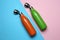 Modern thermo bottles on color background, flat lay