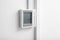 Modern thermostat on white wall