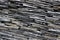 Modern thin slate stone layered wall texture pattern background.