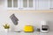 Modern toaster, coffeemaker and dishware on counter