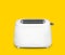 Modern toaster on yellow