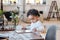 Modern toddler using tablet at table