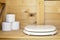 Modern toilet seat of white color in a rustic, wooden restroom WC, in the background rolls of paper