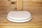 Modern toilet seat with white cover in a wooden, rustic restroom WC