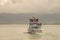 Modern tour boat for big group of tourists is going for a humpback whale at whale watching safari near Reykjavik, Iceland