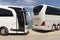 Modern tour buses parked nose to tail in Greece.