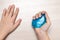 Modern toy called slime. Child playing transparent blue slime. Hands holding a mucus  on a white background