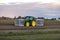 A modern tractor on farmland with a custom-built bulb planting machine with cabin in the South-Holland town of Voorhout in the