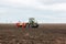 Modern tractor on soil treated cultivator in the field