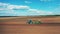 Modern tractor works on a plowed field.