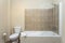 Modern traditional bath, with toilet, bathtub, ceramic tiles all around. With drying, towel,