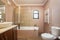 Modern traditional bath, with toilet, bathtub, ceramic tiles all around. With drying, towel,