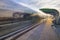 A modern tram stop, blurred silhouette of a passing tram