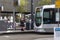 Modern tram stopped at a station platform for passengers in urban city environment