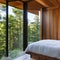 Modern Treehouse: A contemporary treehouse bedroom with large windows offering views of the surrounding trees, seamlessly mergin