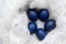 Modern trendy classically blue Easter eggs of the original color on a light wool background close-up with a place for