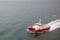 Modern tugboat of red and white color in the sea closeup