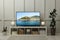 Modern TV set on wooden stand in room. Scene of nature themed movie on screen