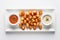 modern twist of Patatas Bravas: A contemporary presentation of crispy potato cubes arranged in a geometric pattern, accompanied by