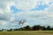 Modern ultralight airplane flying up from field