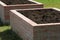 A modern vegetable garden with raised bricks beds . Ready for planting