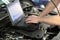 Modern vehicle diagnosis with computer in a garage - mechanic inspects and makes software update