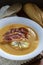 Modern version of Castilian soups with ham and poached eggs