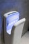 Modern vertical hand dryer in public restroom