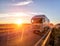 Modern wagon truck transports cargo against the backdrop of a sunset. The concept of truck drivers in the field of freight and