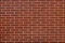 Modern wall is made of red, decorative ceramic clinker brick. Ba