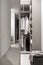 Modern wardrobe with sliding mirrored doors and luminous lamps