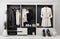 Modern wardrobe with stylish black, white clothes and accessories, cut out on white background