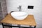 Modern washbasin bowl in bathroom and wooden table. Modern bathroom interior.