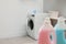 Modern washing machine in light laundry room