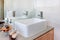 A modern washstand with faucet in front of the mirror in the was