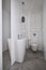 Modern water closet with miror and white walls