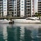 A modern waterfront residential complex with sleek, glass facades and private marina access15