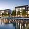 A modern waterfront residential complex with sleek, glass facades and private marina access23