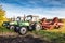 Modern wheeled agricultural tractors with harvesting equipment