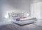 Modern white bedroom interior with violet accents