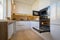 Modern white and beige wooden kitchen interior with oven opened