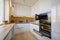 Modern white and beige wooden kitchen interior with oven opened