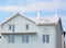 Modern white color house with unfinished balcony, attic skylight window, white tiles roof outdoors