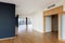 Modern white empty loft apartment interior with parquet floor with black column and panoramic windows, Overlooking the metropolis