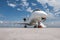 Modern white executive airplane with an opened gangway door at the airport apron