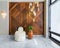 Modern white feather armless chair, tall wooden plant pot, decorated wood cladding wall, and big glass window