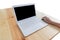 Modern White laptop computer, mouse , hand on wood table, working desk table concept